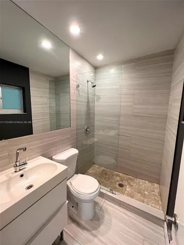 a bathroom with a toilet sink shower and mirror