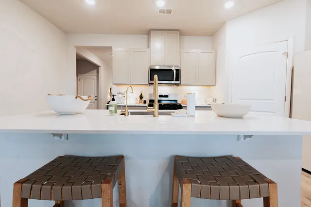 a kitchen with stainless steel appliances a sink and cabinets