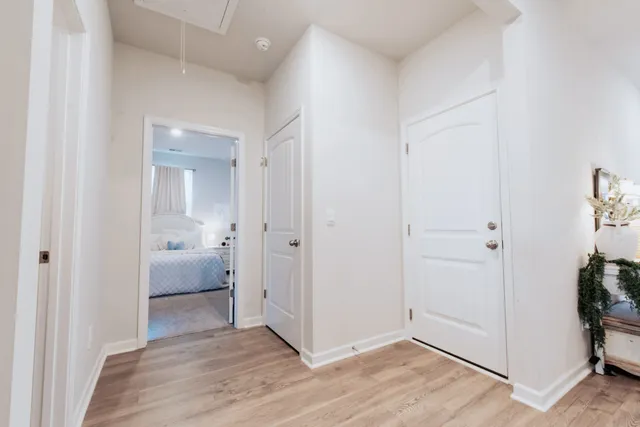 a view of an empty room with wooden floor