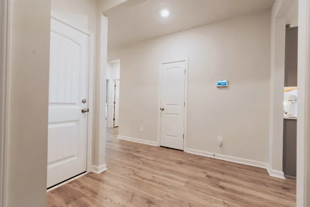 a bedroom with a bed and a potted plant