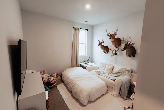 a bedroom with bed and a window