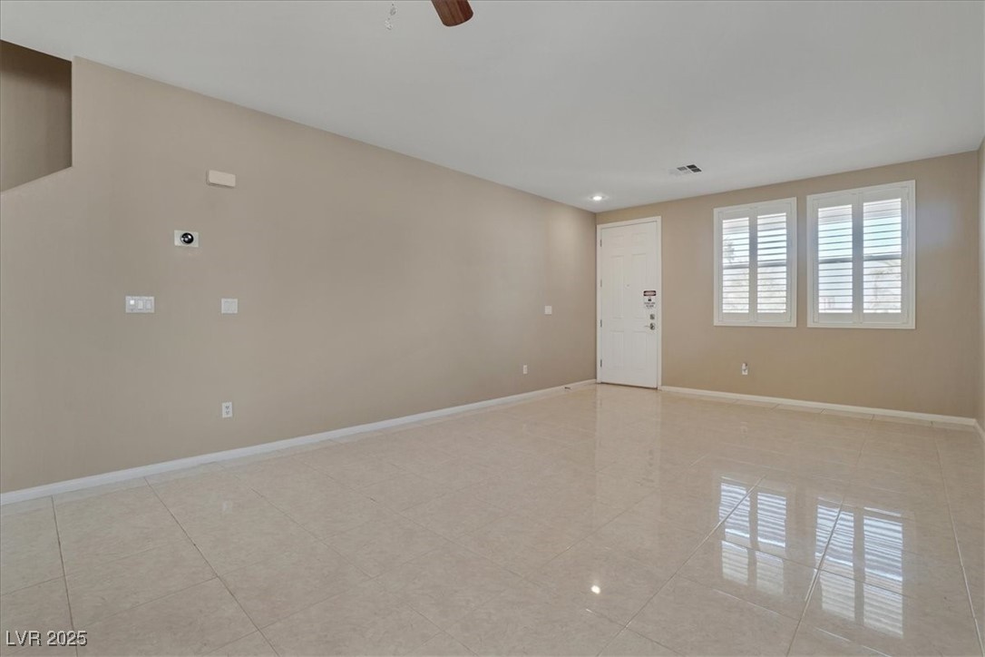 319 Fox Lake Avenue Las Vegas, NV 89148 - Photo 17 of 39 Spare room featuring a ceiling fan and light tile patterned flooring