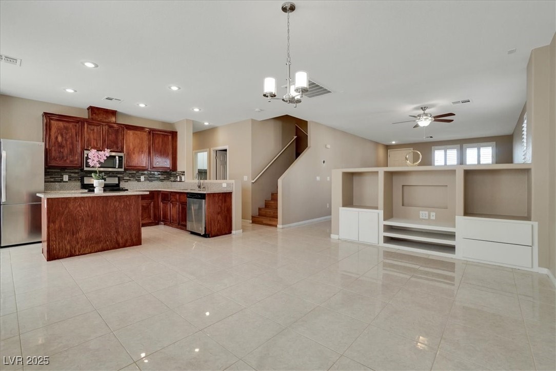 319 Fox Lake Avenue Las Vegas, NV 89148 - Photo 37 of 39 Kitchen featuring stainless steel appliances, open floor plan, hanging light fixtures, backsplash, and recessed lighting
