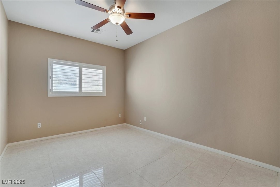 319 Fox Lake Avenue Las Vegas, NV 89148 - Photo 29 of 39 Unfurnished room with light tile patterned flooring and ceiling fan