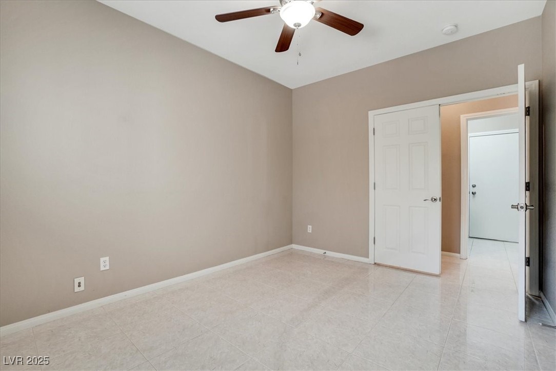 319 Fox Lake Avenue Las Vegas, NV 89148 - Photo 30 of 39 Empty room featuring baseboards and a ceiling fan