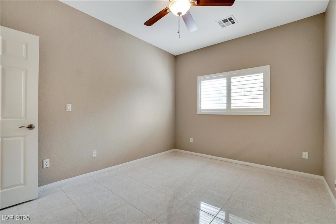 319 Fox Lake Avenue Las Vegas, NV 89148 - Photo 31 of 39 Empty room featuring ceiling fan and light tile patterned floors