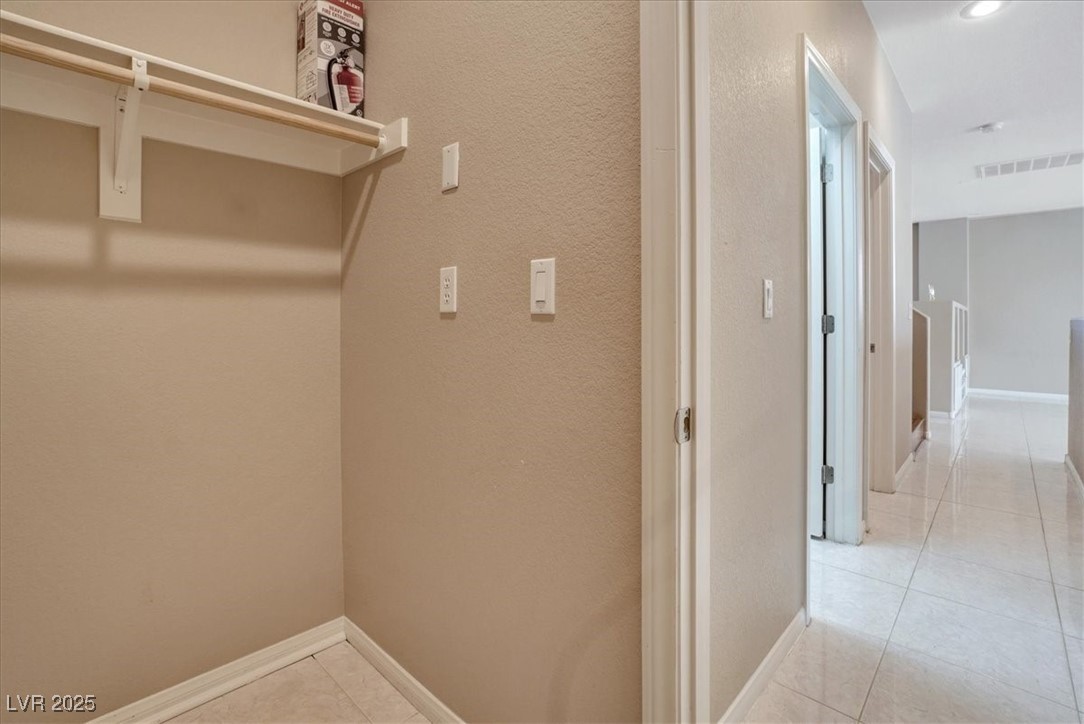 319 Fox Lake Avenue Las Vegas, NV 89148 - Photo 32 of 39 Laundry room with light tile patterned floors and a textured wall