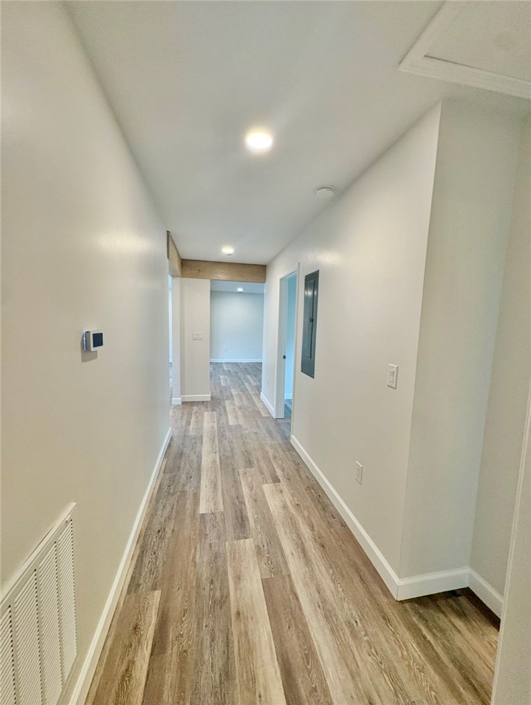 1904 East Calhoun Street Anderson, SC 29621 - Photo 19 of 36 A well-lit corridor boasts recessed lighting and durable plank flooring.