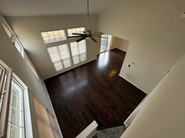 a view of staircase with wooden floor and black carpet