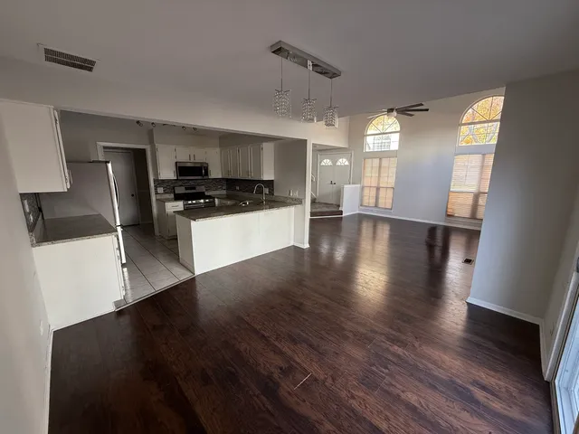 a view of a kitchen with a sink and a stove top oven