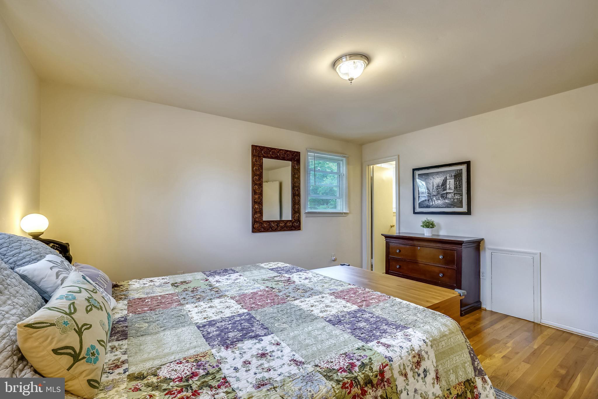 11806 Seven Locks Road Potomac, MD 20854 - Photo 24 of 44 a bedroom with a bed and a dresser