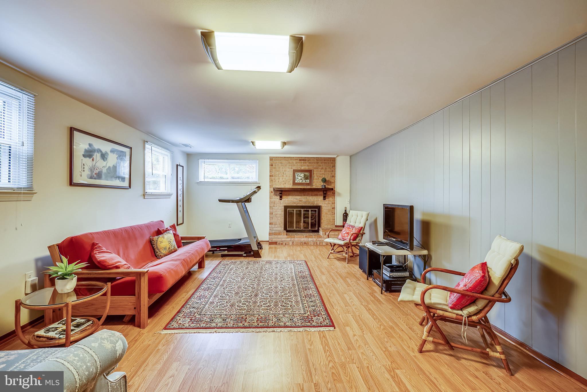 11806 Seven Locks Road Potomac, MD 20854 - Photo 29 of 44 a living room with furniture a flat screen tv and a fireplace