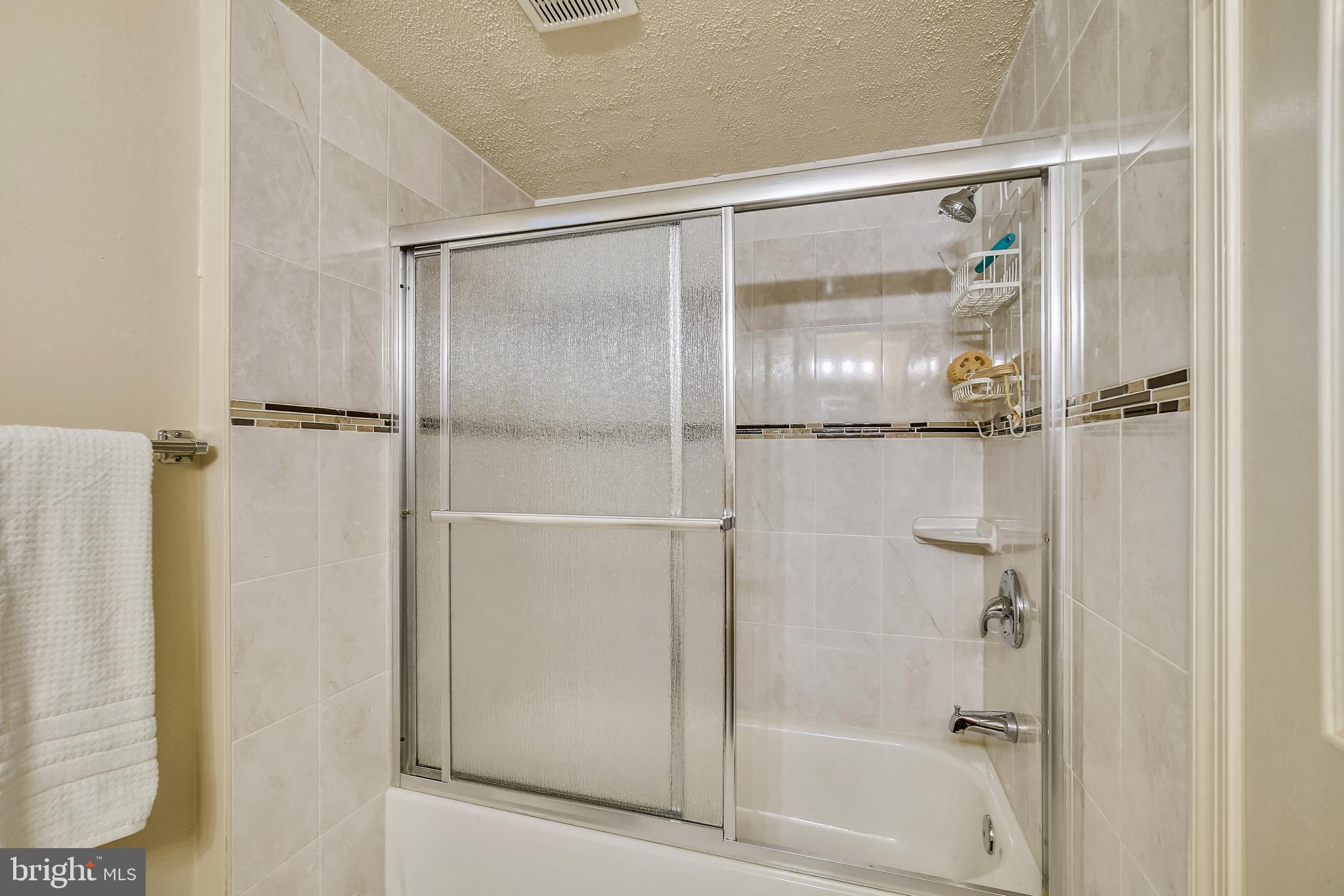 11806 Seven Locks Road Potomac, MD 20854 - Photo 33 of 44 a bathroom with a glass shower door
