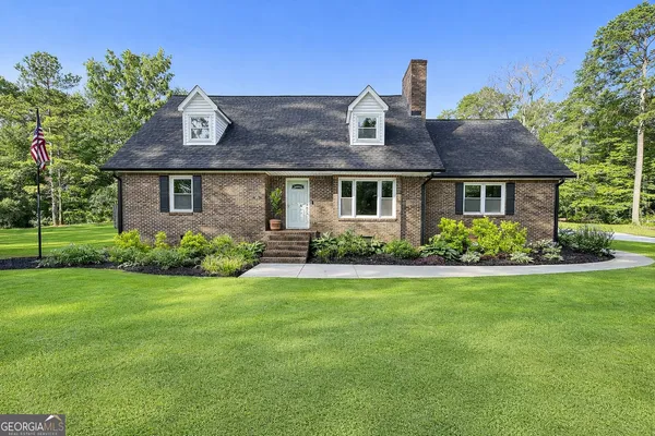 a front view of a house with garden