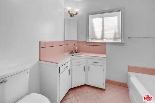 a bathroom with a sink a vanity and a mirror