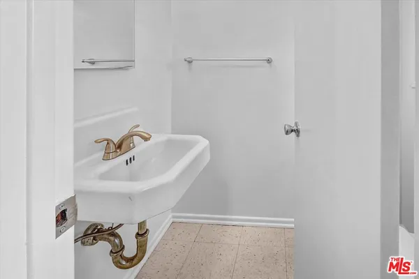 a bathroom with a sink and mirror
