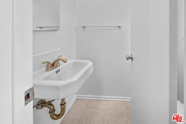 a bathroom with a sink and mirror