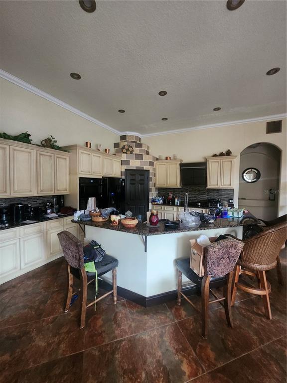 2930 Marsh Road DeLand, FL 32724 - Photo 13 of 30 a living room with furniture a flat screen tv and kitchen view