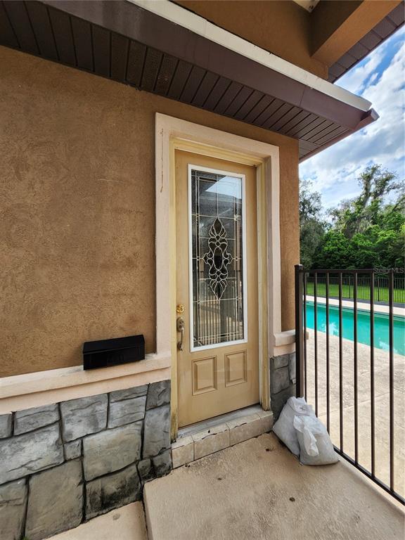 2930 Marsh Road DeLand, FL 32724 - Photo 25 of 30 a view of a porch with furniture and floor to ceiling window