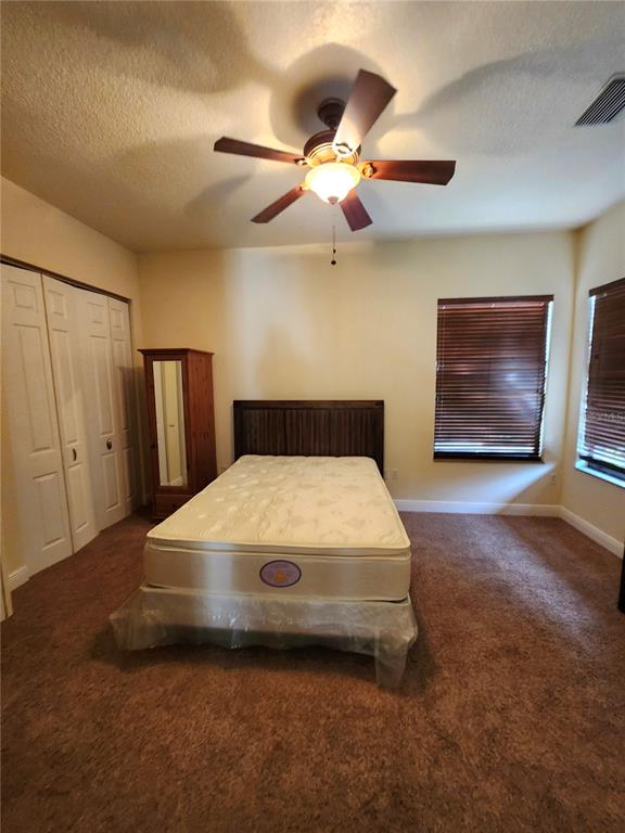 2930 Marsh Road DeLand, FL 32724 - Photo 26 of 30 a bedroom with a bed and a ceiling fan