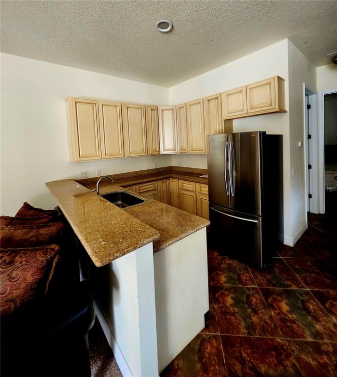 2930 Marsh Road DeLand, FL 32724 - Photo 28 of 30 a kitchen that has a sink and a refrigerator