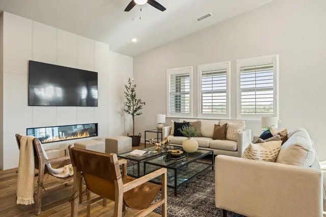 a living room with furniture and a wooden floor