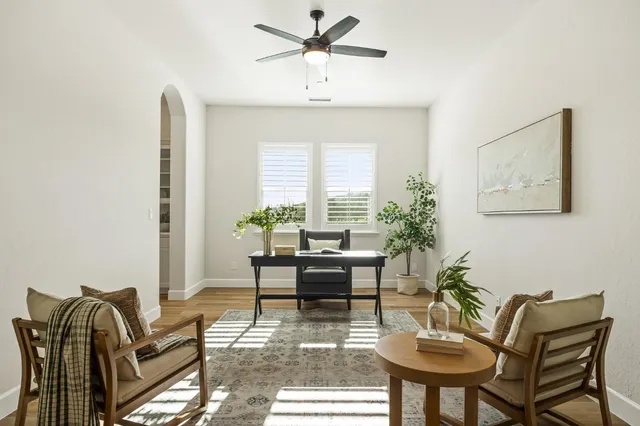 a view of room with wooden floor and ceiling fan