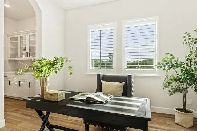a view of a room with wooden floor and white walls