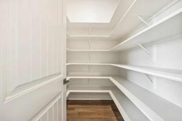a view of a sink a window and a view of living room