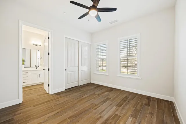 a kitchen with cabinets and a wooden floor