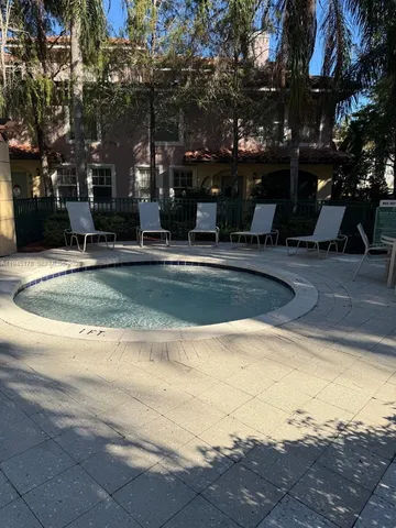 a swimming pool with outdoor seating and yard