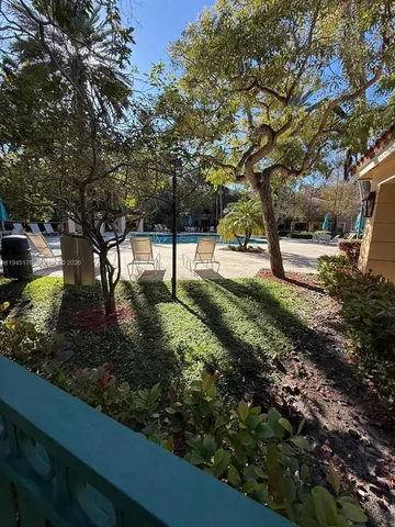 a view of a patio with a table and chairs