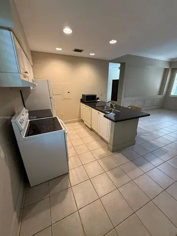 a kitchen with a cabinets and appliances