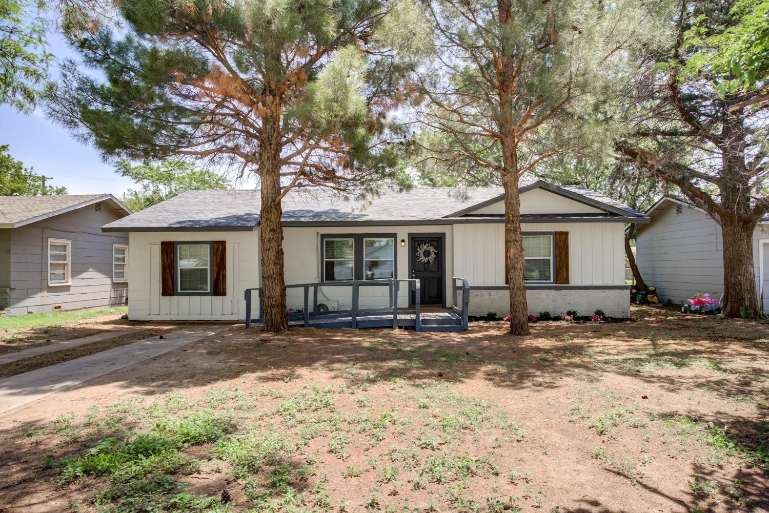 a view of a house with a tree in front of it