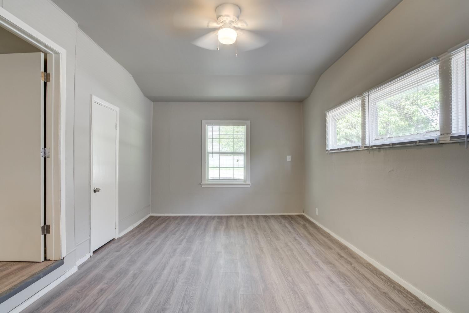 4629 Elgin Avenue Lubbock, TX 79413 - Photo 17 of 34 wooden floor in an empty room with a window