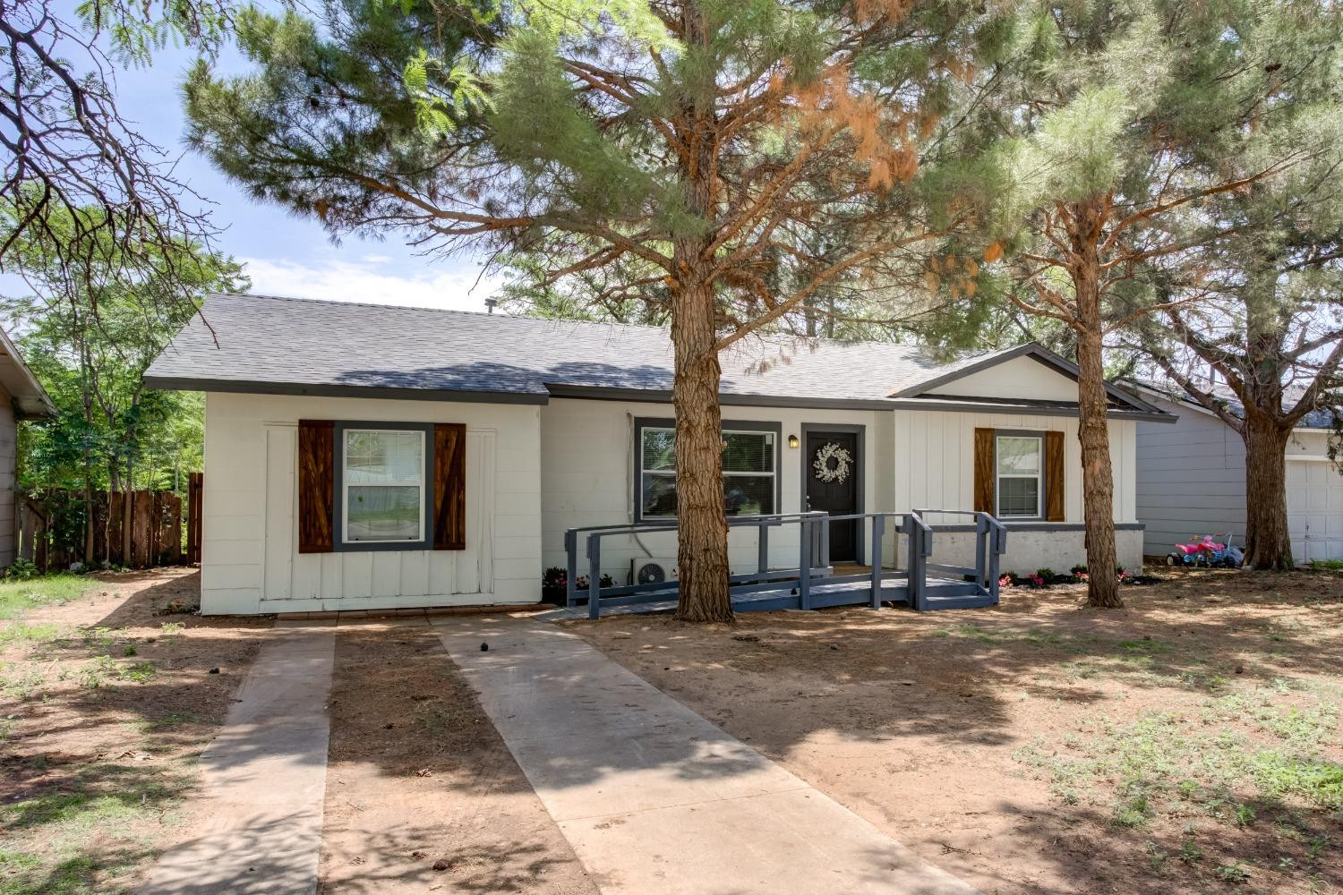 4629 Elgin Avenue Lubbock, TX 79413 - Photo 2 of 34 a front view of a house with a yard