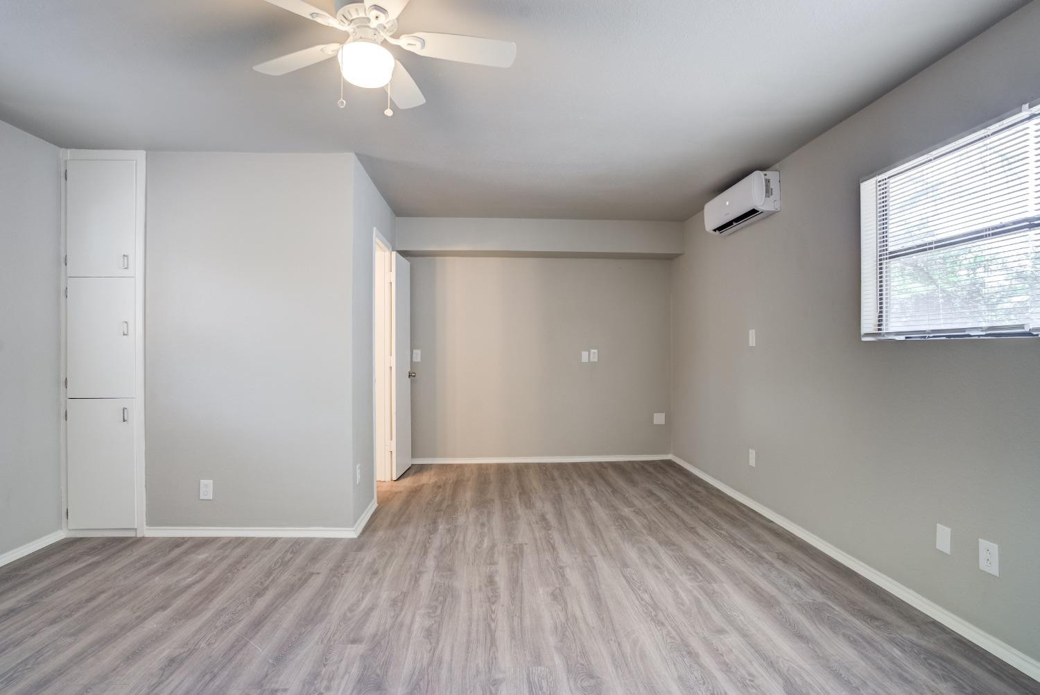 4629 Elgin Avenue Lubbock, TX 79413 - Photo 22 of 34 wooden floor in an empty room with a window