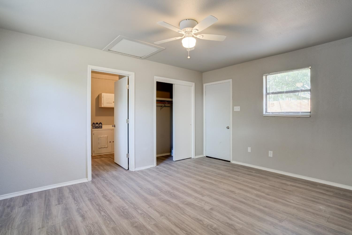4629 Elgin Avenue Lubbock, TX 79413 - Photo 25 of 34 wooden floor in an empty room with a window