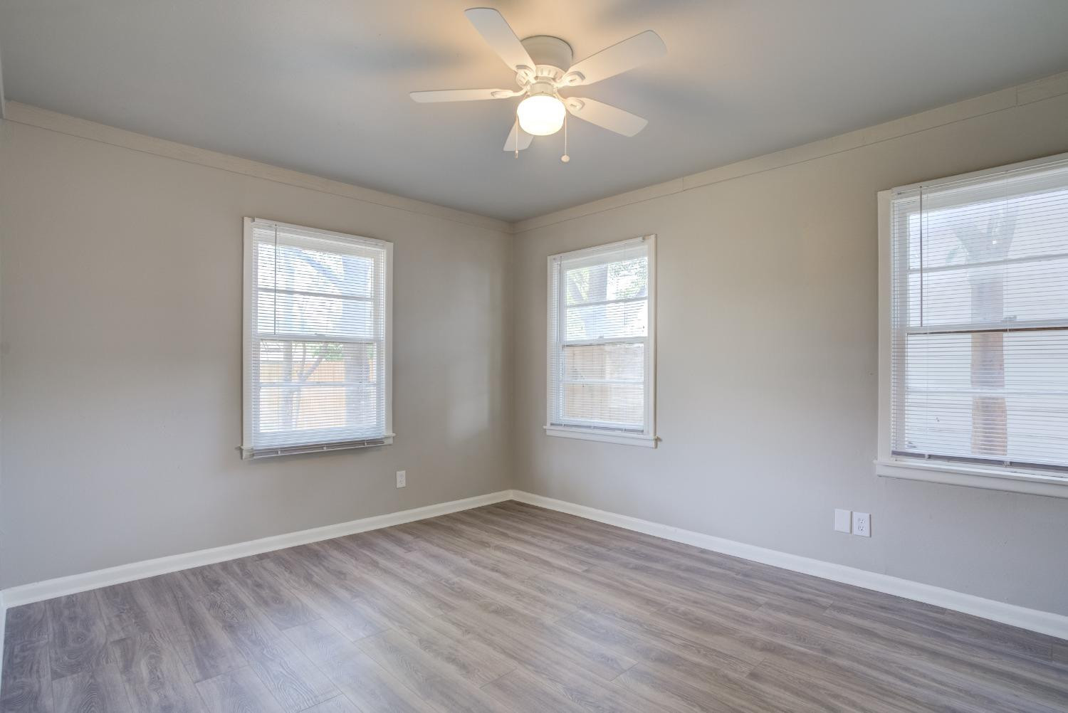 4629 Elgin Avenue Lubbock, TX 79413 - Photo 30 of 34 an empty room with wooden floor and windows