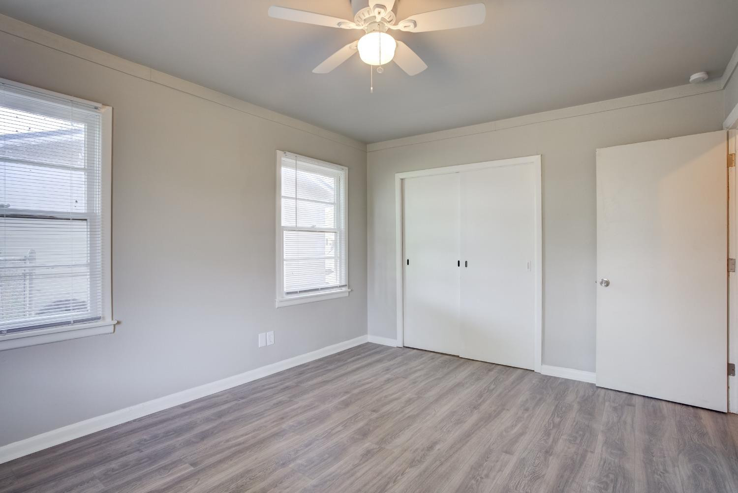 4629 Elgin Avenue Lubbock, TX 79413 - Photo 31 of 34 wooden floor in an empty room with a window