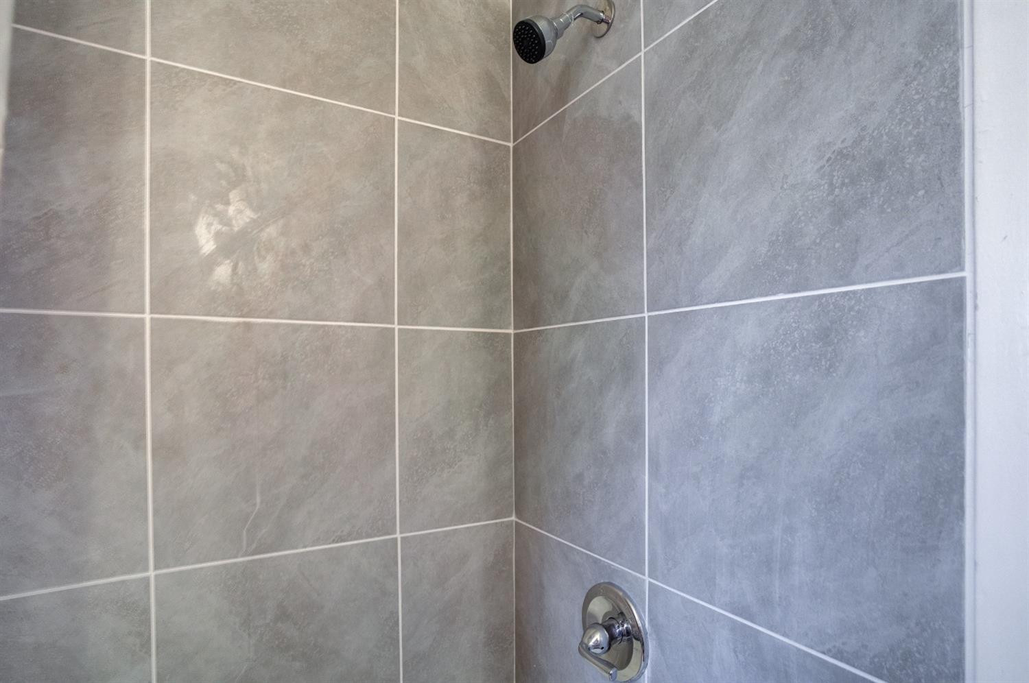 4629 Elgin Avenue Lubbock, TX 79413 - Photo 33 of 34 a bathroom with a shower and a sink