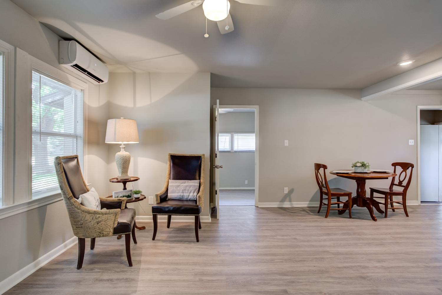 4629 Elgin Avenue Lubbock, TX 79413 - Photo 5 of 34 a view of a dining room with furniture and wooden floor