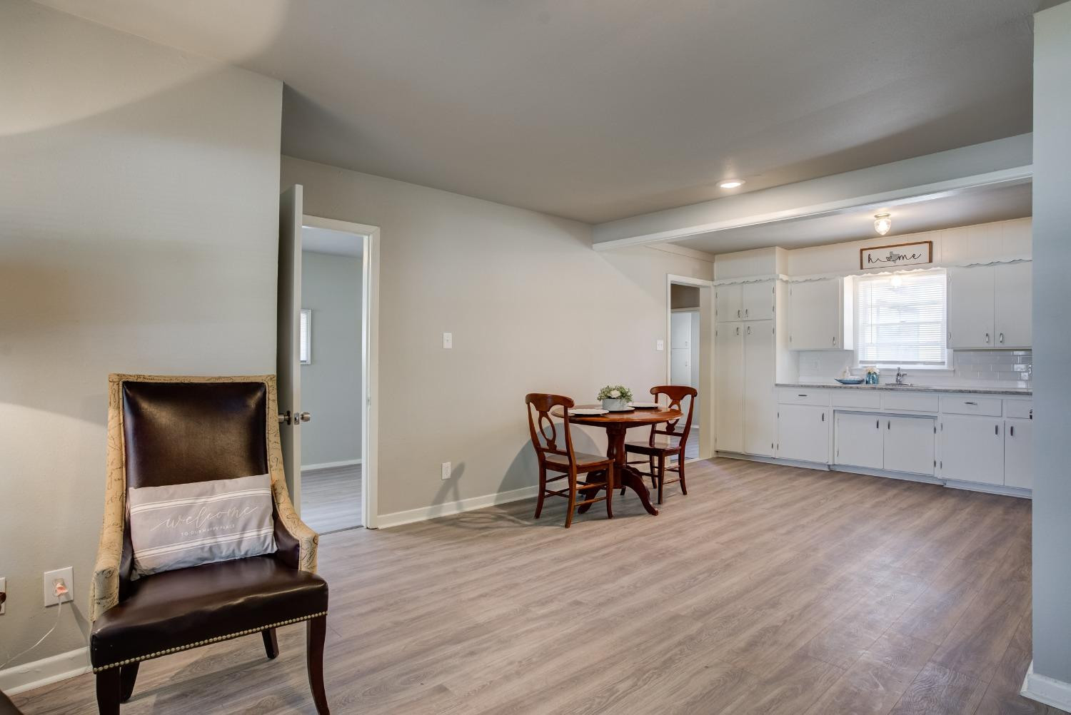 4629 Elgin Avenue Lubbock, TX 79413 - Photo 6 of 34 a workspace room with wooden floor furniture and windows