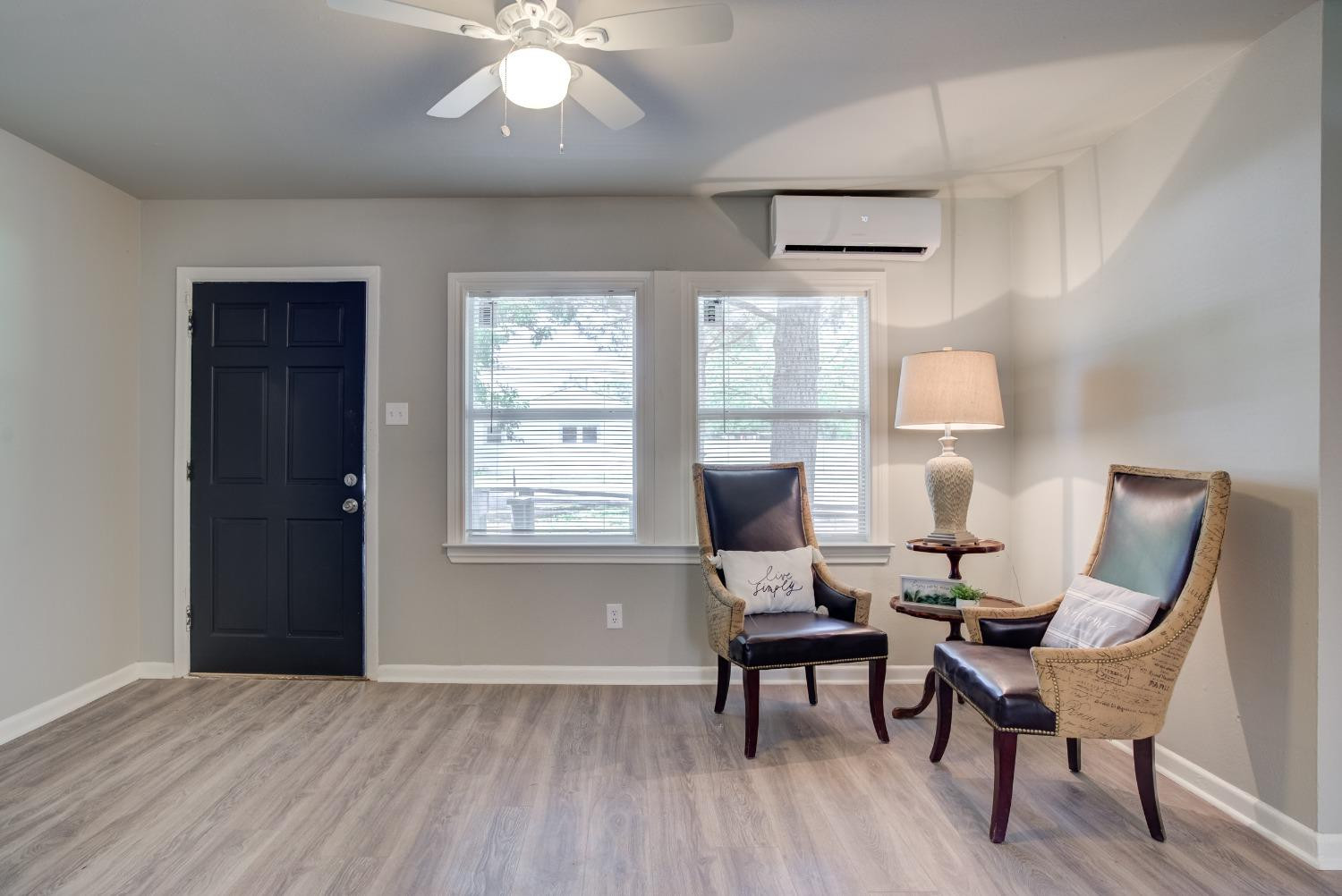 4629 Elgin Avenue Lubbock, TX 79413 - Photo 7 of 34 a workspace with wooden floor and a chandelier fan
