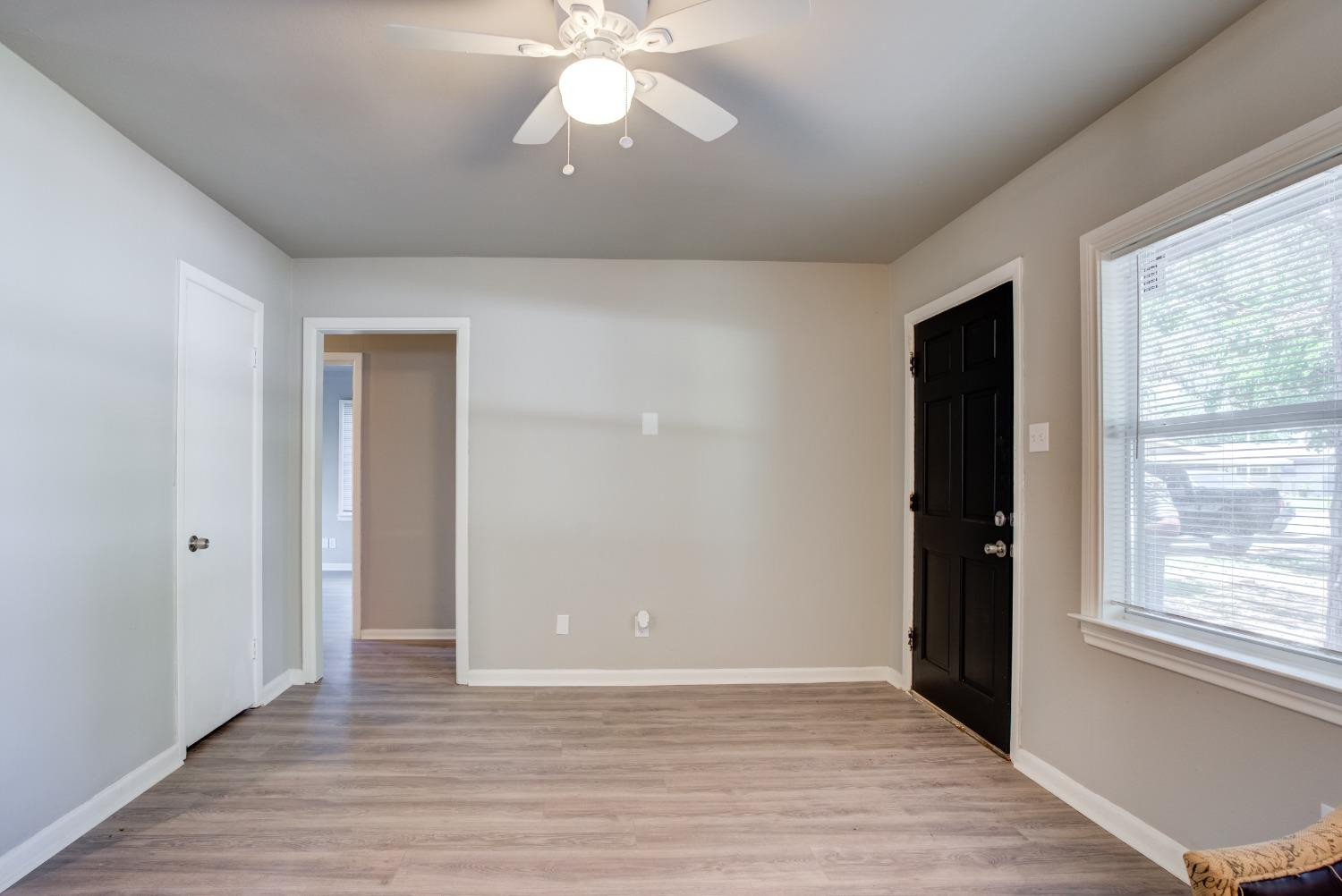 4629 Elgin Avenue Lubbock, TX 79413 - Photo 9 of 34 wooden floor in an empty room with a window