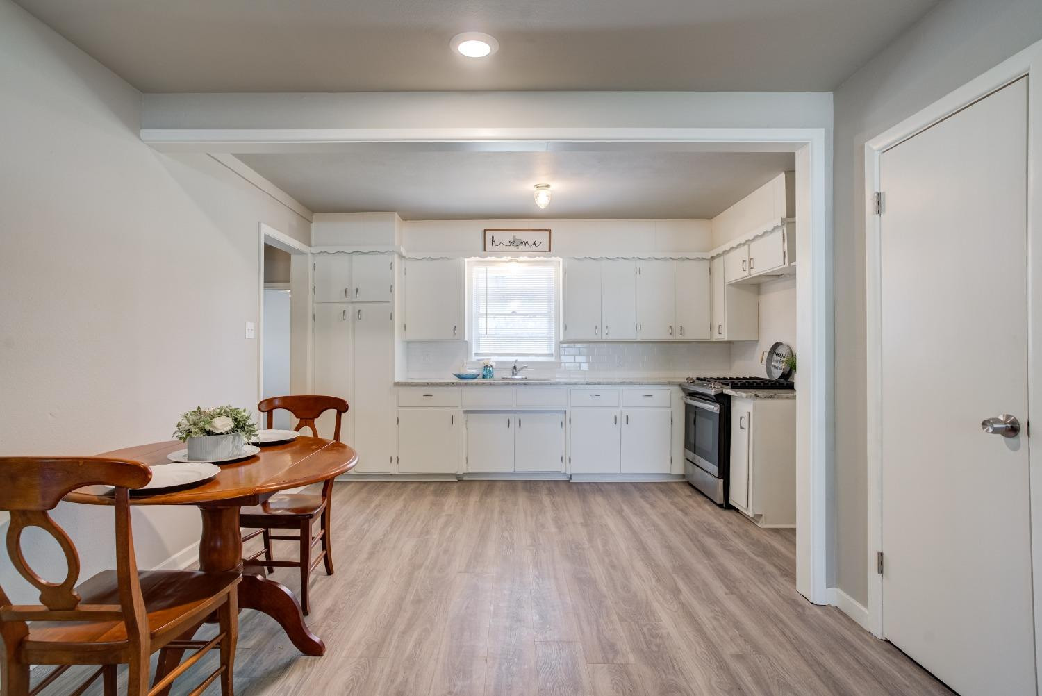 4629 Elgin Avenue Lubbock, TX 79413 - Photo 10 of 34 a kitchen with stainless steel appliances kitchen island hardwood floor sink and stove