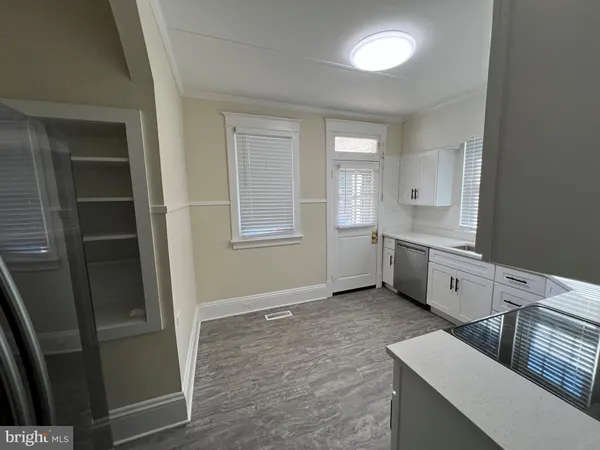 a kitchen with white cabinets and white appliances