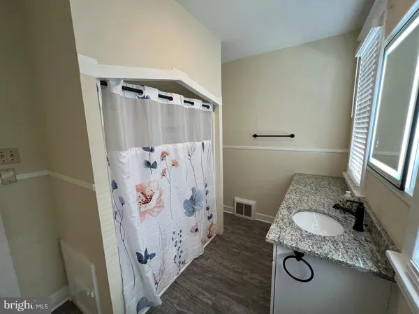 a bathroom with a tub and shower