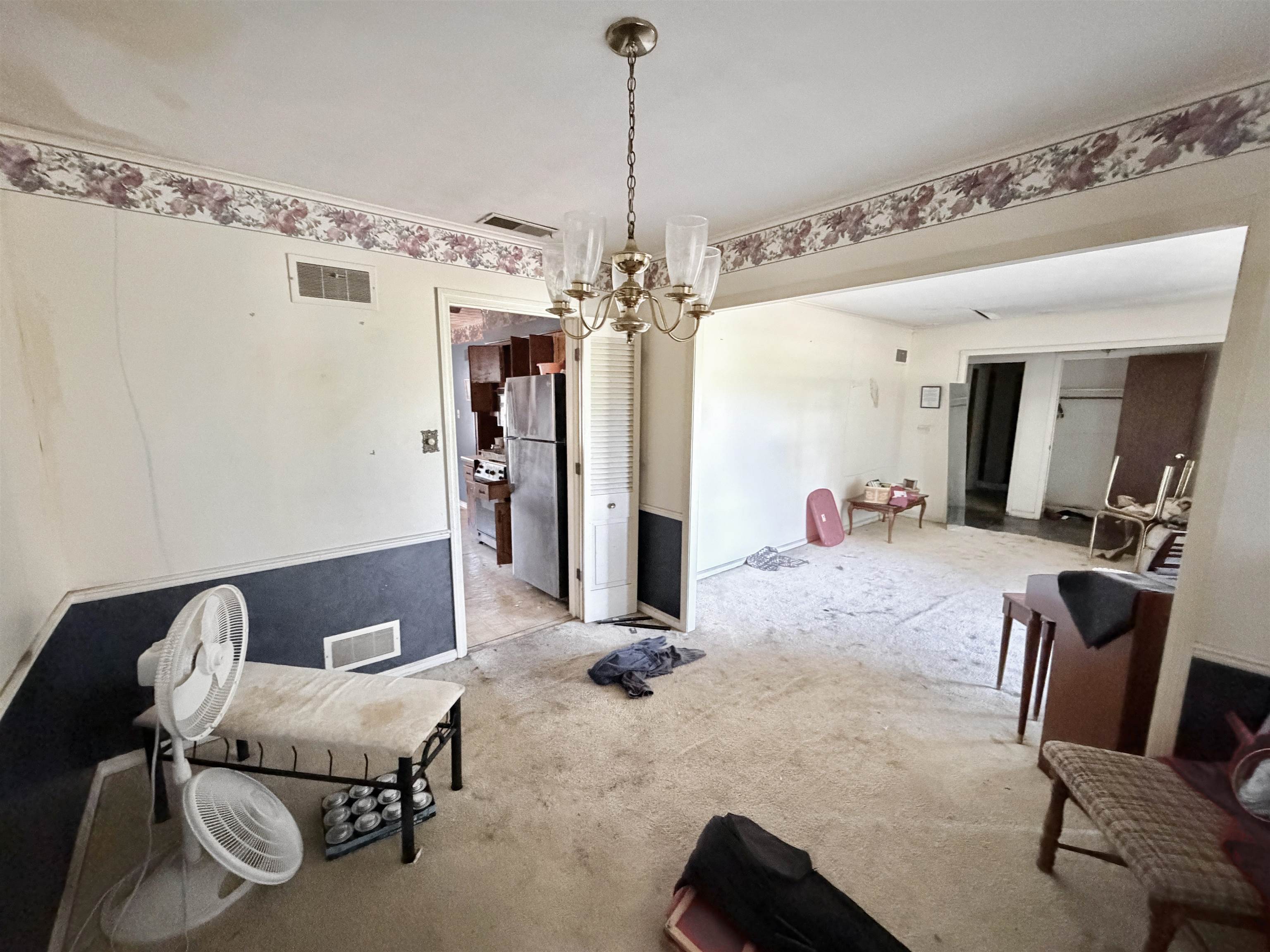 5536 Cottonwood Road Memphis, TN 38115 - Photo 28 of 28 Spacious interior room featuring a brass-finish chandelier and an open doorway to another room