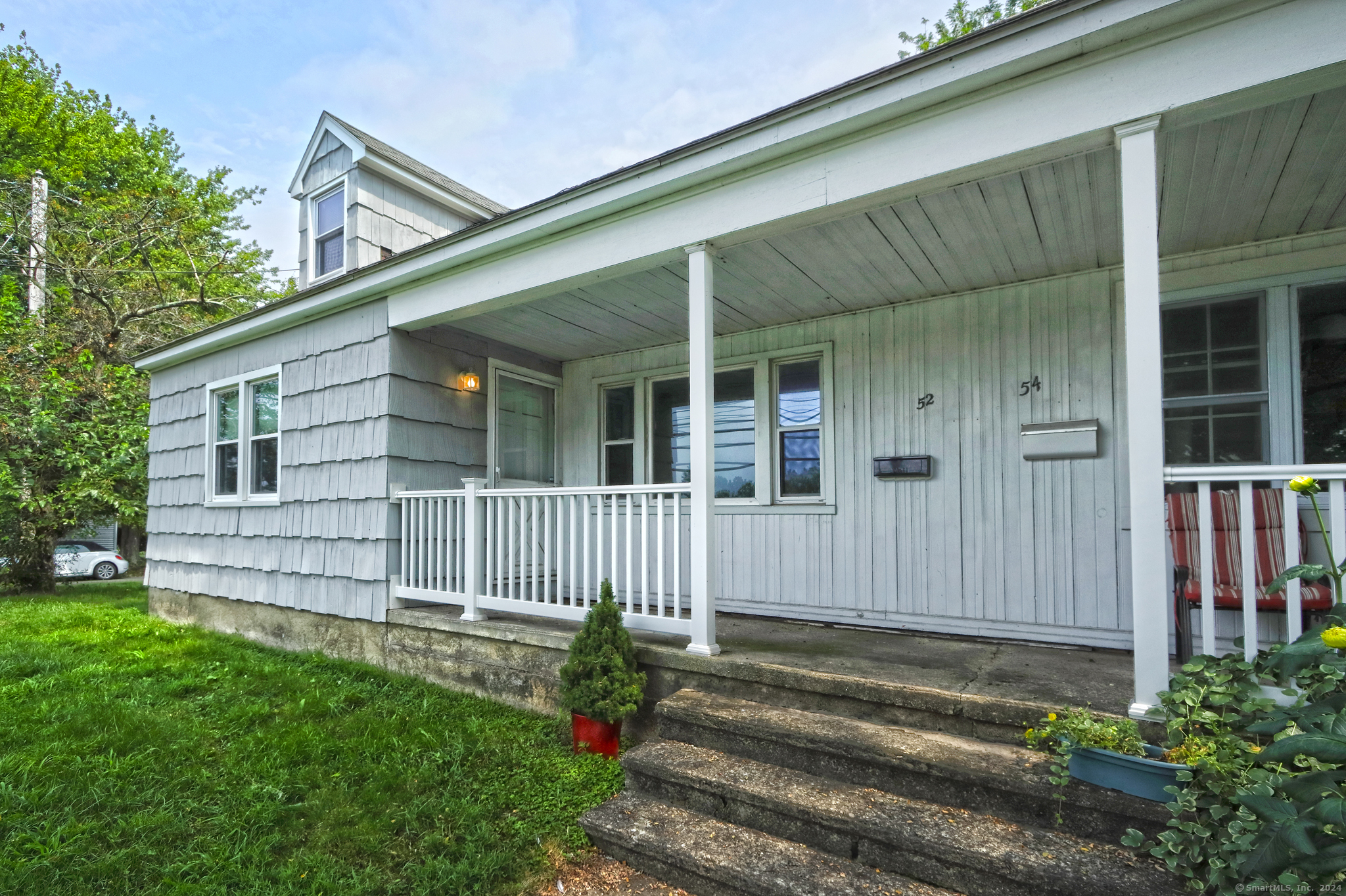 a view of a house with a small yard and wooden fence